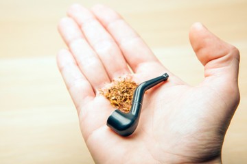 Fototapeta premium smoking pipe hand table background 