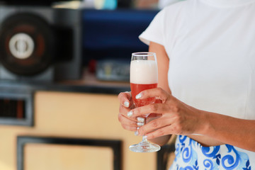 Close up woman hand Holding  Glass of Foamy Beer
