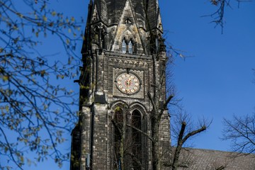 Church Spire with clock of the neo-gothic Kirche am Suedstern in Kreuzberg. Was build 1894 to 1897.