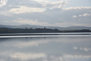 Autumn landscape with forest reflection on the lake in Poland.
