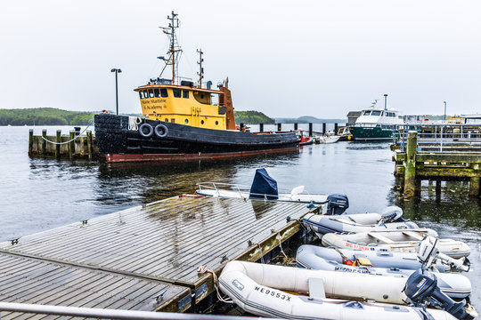 Castine, USA - June 9, 2017: Empty Wooden Marina Harbor In Small Village In Maine During Rain With Many Boats And Barge