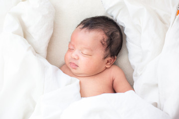 Newborn infant boy sleep on white blanket