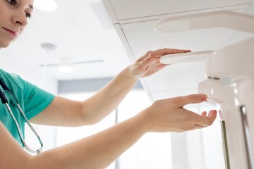 Nurse washing her hands in clinic