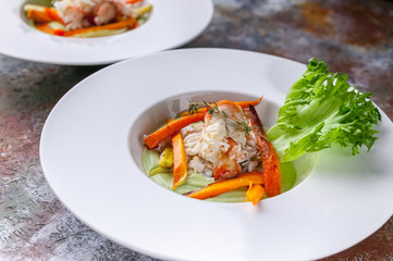 Close-up salad with snow crab meat, avocado and vegetables. Two servings on a rusty background