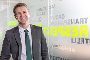 Smiling businessman standing in office