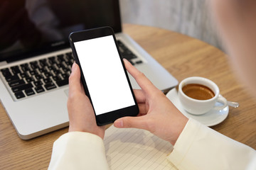 Cropped shot view of business woman’s hands holding the mobile phone with blank copy space screen for your information content or text message, the woman reading text message on the smart phone .