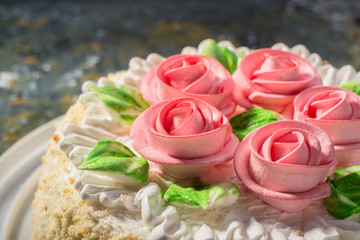 cake with roses close-up on a warm background. confectionery