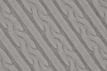 Fototapeta na wymiar Knitwear Fabric Texture with Pigtails and stripes. Repeating Machine Knitting Texture of Sweater. Gray Knitted Background. Diagonal composition.