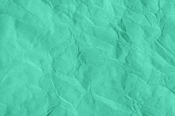 Trendy mint colored textured background. Crumpled craft paper texture. Flat lay. Year color concept.