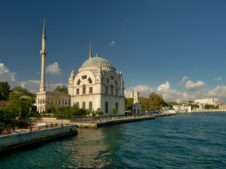 The beautiful Dolmabahce mosque on the banks of the Bosphorus strait with the Domabahche palace in the far right.