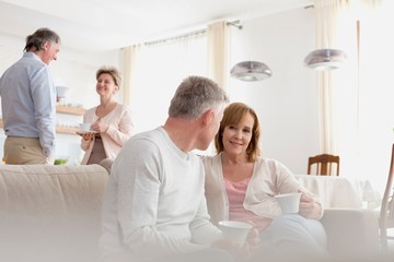 Obraz premium Mature couples talking in living room at home