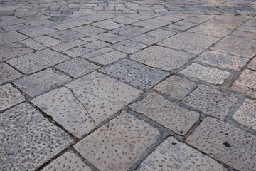 Pavement of stone rectangular blocks of different sizes. Italy, Polignano.