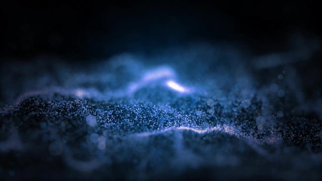 Abstract premium wave animated motion graphic on black background, seamless loop. Animation. White and blue particles move on middle backdrop.