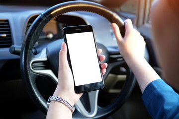 Cropped shot view of business woman’s hands holding the mobile phone with blank copy space screen for your  content or text message, the woman reading text message on the smart phone in the car.