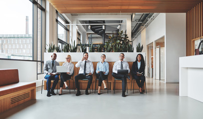 Diverse businesspeople waiting for their interviews in an office