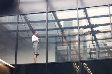 Businesswoman using smartphone in office
