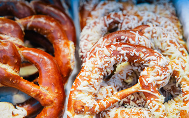 Bretzel baked pastry on Christmas market in Germany in Europe in winter. German Night street Xmas and holiday fair in European city or town, December. Kaiser Wilhelm Memorial Church, Berlin