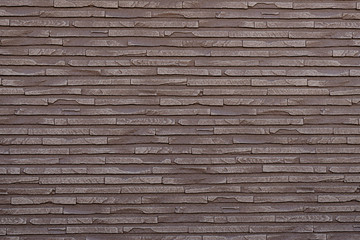 Wall from a decorative stone. Texture, architectural background, tiles of various sizes. Artificial stone