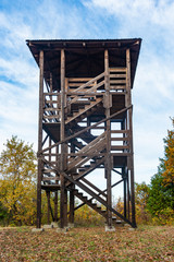 Autumn landscape with a hunting tower. Wooden hunter perched at the forest edge. The observation tower in Fruska Gora, Serbia.