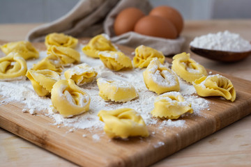 Italian pasta fresh raw tortellini covered with flour Ready to cook Italian food concept.