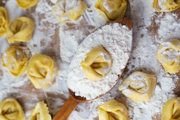 Italian pasta fresh raw tortellini covered with flour Ready to cook Italian food concept.