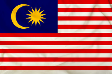 national flag of Malaysia on a silk cloth with folds from the wind, a symbol of tourism, immigration, politic