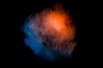 Orange blue  powder explosion on black background.Orange blue color dust splash clouds.