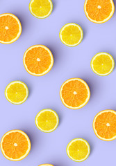 pattern of fresh orange slices and lemon on colored background. Citrus fruit pattern top view.