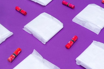 women's sanitary pads and tampons on a purple background