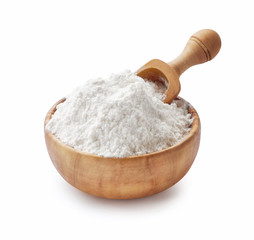 Fototapeta na wymiar Wooden Bowl with flour and flour spoon. Rice or wheat flour isolated on white background.