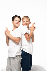 two cheerful brothers standing back to back and showing gun gestures isolated on white