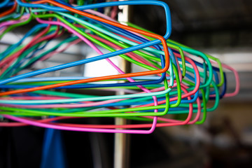 colorful plastic hangers on rack