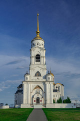 Fototapeta premium Dormition Cathedral bell tower, with blue sky and white clouds, Vladimir, Russia