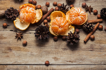Tangerines, cones, spices on a wooden background. Сoncept of New Year and Christmas, Christmas drink Mulled wine. Flat lay, top view