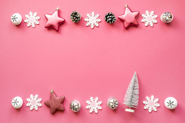 Christmas decorations on a pink background, top view, copy space. Festive Christmas bright background	