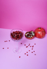 Glass filled with fresh pomegranate seeds 