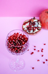 Glass filled with fresh pomegranate seeds 