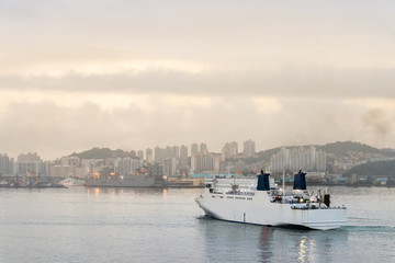 Fototapeta premium Ship approaching the port of Busan at a cloudy day, South Korea.