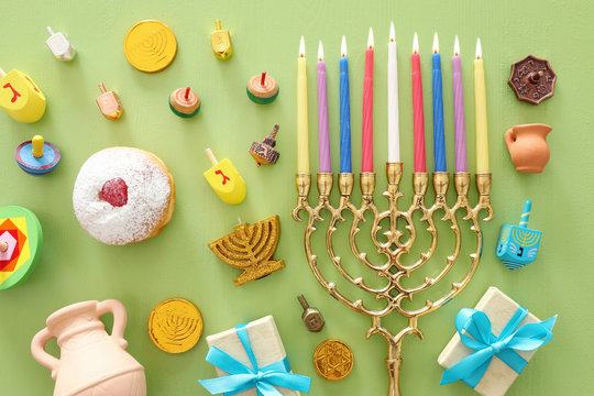 religion image of jewish holiday Hanukkah background with menorah (traditional candelabra), spinning top and doughnut