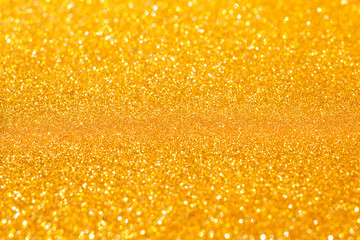 New Year,Xmas Golden abstract sparkles or glitter lights.2020.Defocused circles bokeh or particles.Template for design.Blurred golden holiday abstract glitter defocused background with blinking stars.