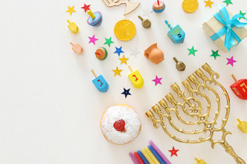 Fototapeta na wymiar religion image of jewish holiday Hanukkah background with menorah (traditional candelabra), spinning top and doughnut