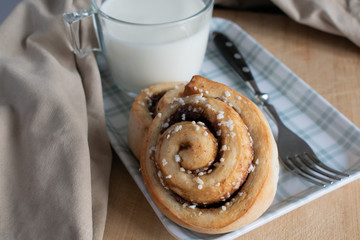cinnamon rolls with glass of milk on the table
