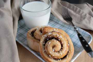 cinnamon rolls with glass of milk on the table