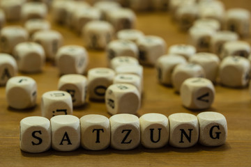 Satzung in german with wooden cubes written