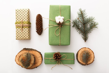Obraz na płótnie Canvas Zero waste Christmas composition background made of pine cones, branches, candle, tree rings, crafted gifts with no plastic on white table. Top view, close up, copy space, background, flat lay.