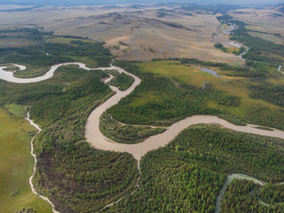 Aerial view of Kurai steppe and Chuya river on North-Chui ridge background. Altai mountains, Russia.