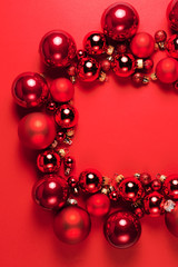 Christmas composition. Christmas red decorations on red background. Flat lay. Christmas and happy new year concept for Christmas promotion banner