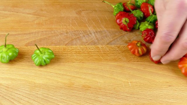 slitting hot chili peppers at preparation of pique sauce, a Puerto Rican hot sauce 4k
