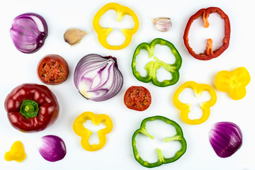 Garlic, sweet salad pepper sliced ​​in circles of different colors isolated on a white background.