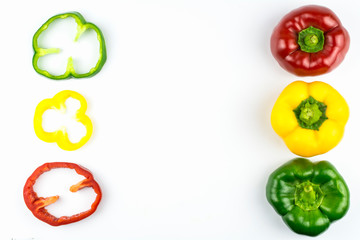 Sweet pepper sliced ​​in circles of green, yellow and red color isolated on a white background.